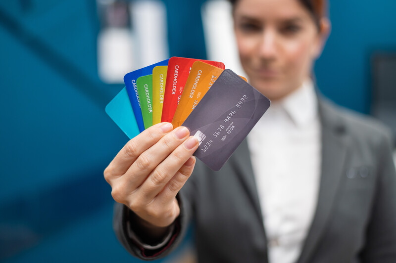 A woman showing a few credit or debit cards