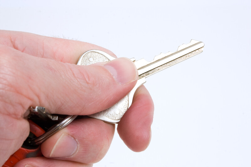 A hand holding a key