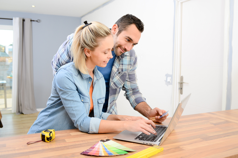Two people looking at remortgage options on a laptop